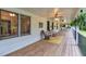 Inviting covered porch with wood floors, rocking chairs, ceiling fans and outdoor decor at 143 Navajo Trl, Rydal, GA 30171