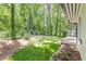 Large, grassy backyard bordered by lush trees and a wood deck at 1992 Cascade Sw Rd, Atlanta, GA 30311