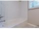 A bathroom features a white subway tile shower and chrome fixtures at 1992 Cascade Sw Rd, Atlanta, GA 30311