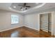 This bedroom features hardwood floors, a ceiling fan, and a closet with built-in shelves at 1992 Cascade Sw Rd, Atlanta, GA 30311