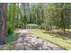 Long driveway leading to a charming one-story home surrounded by lush trees at 1992 Cascade Sw Rd, Atlanta, GA 30311