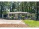 Charming, one-story home with a well-manicured lawn, carport, and inviting front porch at 1992 Cascade Sw Rd, Atlanta, GA 30311