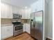 Bright kitchen featuring stainless steel appliances, white cabinets, and granite countertops at 1992 Cascade Sw Rd, Atlanta, GA 30311