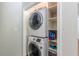 Convenient stacked laundry in closet with shelving for storage at 1992 Cascade Sw Rd, Atlanta, GA 30311