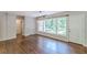 Bright living room featuring hardwood floors, a large window, and a modern chandelier at 1992 Cascade Sw Rd, Atlanta, GA 30311