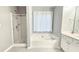 Bright bathroom with a separate shower and tub, complemented by a window with decorative curtains at 2203 Beacon Crest Dr, Buford, GA 30519