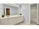 Bright bathroom featuring a double sink vanity and tub with white tile surround at 2203 Beacon Crest Dr, Buford, GA 30519