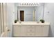 Bright bathroom with light-blue walls, double vanity, and white cabinets at 2203 Beacon Crest Dr, Buford, GA 30519