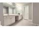 Bathroom featuring double vanity, long mirrors, and tiled flooring at 2203 Beacon Crest Dr, Buford, GA 30519