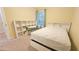 Bedroom with neutral carpet, a bed, built-in shelves, and a desk near a window at 2203 Beacon Crest Dr, Buford, GA 30519