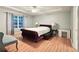 Comfortable bedroom with tray ceiling, large windows, and hardwood floors at 2203 Beacon Crest Dr, Buford, GA 30519