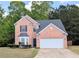 Charming brick home with a well-manicured lawn and two-car garage at 2203 Beacon Crest Dr, Buford, GA 30519