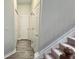Hallway with neutral paint, leading to multiple rooms and stairway at 2203 Beacon Crest Dr, Buford, GA 30519