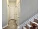 Bright hallway with wood floors and white doors leads to the stairs at 2203 Beacon Crest Dr, Buford, GA 30519