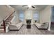 Cozy living room with hardwood floors, fireplace, and plenty of natural light at 2203 Beacon Crest Dr, Buford, GA 30519