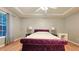 Bright main bedroom with tray ceilings and plush, tufted king-size bed at 2203 Beacon Crest Dr, Buford, GA 30519