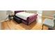 Bright main bedroom with wood floors, bedside table and stylish blue chair at 2203 Beacon Crest Dr, Buford, GA 30519