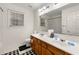 Bathroom featuring double sink vanity with white countertops and wood cabinets at 10 Bunker Lane St, Covington, GA 30014