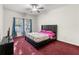 Comfortable bedroom featuring a large window, ceiling fan, and a double bed at 10 Bunker Lane St, Covington, GA 30014