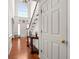 Bright entryway with hardwood floors, white staircase, and a soaring arched window at 10 Bunker Lane St, Covington, GA 30014