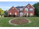Charming two-story brick home with a well-manicured lawn and mature trees at 10 Bunker Lane St, Covington, GA 30014