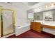 Bright bathroom featuring double sink vanity, shower, and a soaking tub at 10 Bunker Lane St, Covington, GA 30014