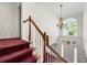 Grand foyer with a staircase featuring wood railing, white balusters, and a large window at 10 Bunker Lane St, Covington, GA 30014