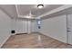 Finished basement with modern flooring, closet, access door, and natural light at 1635 Rushing River Way, Suwanee, GA 30024