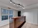 Finished basement with custom bar with unique wood design and modern track lighting at 1635 Rushing River Way, Suwanee, GA 30024