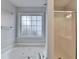 Bright bathroom features soaking tub under a window and glass enclosed shower at 1635 Rushing River Way, Suwanee, GA 30024