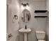 Stylish powder room featuring a pedestal sink and modern fixtures at 1635 Rushing River Way, Suwanee, GA 30024