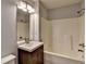 Bathroom with dark wooden cabinets and bath at 1635 Rushing River Way, Suwanee, GA 30024
