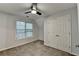 Bedroom with neutral carpet, double closet and window overlooking trees at 1635 Rushing River Way, Suwanee, GA 30024