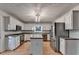 Spacious kitchen features stainless steel appliances, granite countertops, and a central island at 1635 Rushing River Way, Suwanee, GA 30024