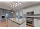 Open kitchen view to the living room, featuring an island, and stainless steel appliances at 1635 Rushing River Way, Suwanee, GA 30024