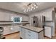 Kitchen featuring an island with granite counters, and stainless steel appliances at 1635 Rushing River Way, Suwanee, GA 30024