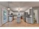 Spacious kitchen featuring an island, stainless steel appliances, granite counters, and white cabinetry at 1635 Rushing River Way, Suwanee, GA 30024