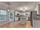 Bright kitchen with stainless steel appliances, granite counters, and an island at 1635 Rushing River Way, Suwanee, GA 30024