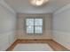 Clean, neutral room with paneling, a white rug, and a window at 1635 Rushing River Way, Suwanee, GA 30024