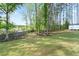 Serene backyard featuring a lush lawn, mature trees, and a storage shed, creating a private oasis at 505 Alta Ct, Villa Rica, GA 30180