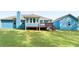Home's backyard with covered deck, grassy area, and blue siding at 505 Alta Ct, Villa Rica, GA 30180
