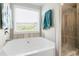 Bright bathroom with a soaking tub, a separate shower, and updated fixtures at 505 Alta Ct, Villa Rica, GA 30180