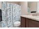 This bathroom features a shower with patterned curtain and granite vanity at 505 Alta Ct, Villa Rica, GA 30180