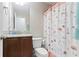 Bright bathroom featuring a granite-topped vanity and decorative shower curtain at 505 Alta Ct, Villa Rica, GA 30180