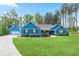 Charming blue home with a well-manicured lawn, complemented by a two-car garage and beautiful landscaping at 505 Alta Ct, Villa Rica, GA 30180