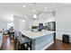 Open kitchen features a large island with granite countertops, stainless steel appliances, and modern lighting at 505 Alta Ct, Villa Rica, GA 30180