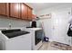 Well-equipped laundry room features upper cabinets and modern appliances at 505 Alta Ct, Villa Rica, GA 30180