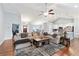 Open-concept living area with a large sectional sofa, hardwood floors, and seamless flow to the dining and kitchen spaces at 505 Alta Ct, Villa Rica, GA 30180