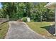 View of the backyard featuring mature trees, a storage shed, and a well-maintained lawn at 1345 Sw Dodson Dr, Atlanta, GA 30311