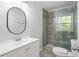 Modern bathroom boasts a stylish vanity, toilet, and glass-enclosed shower with tiled walls at 1345 Sw Dodson Dr, Atlanta, GA 30311